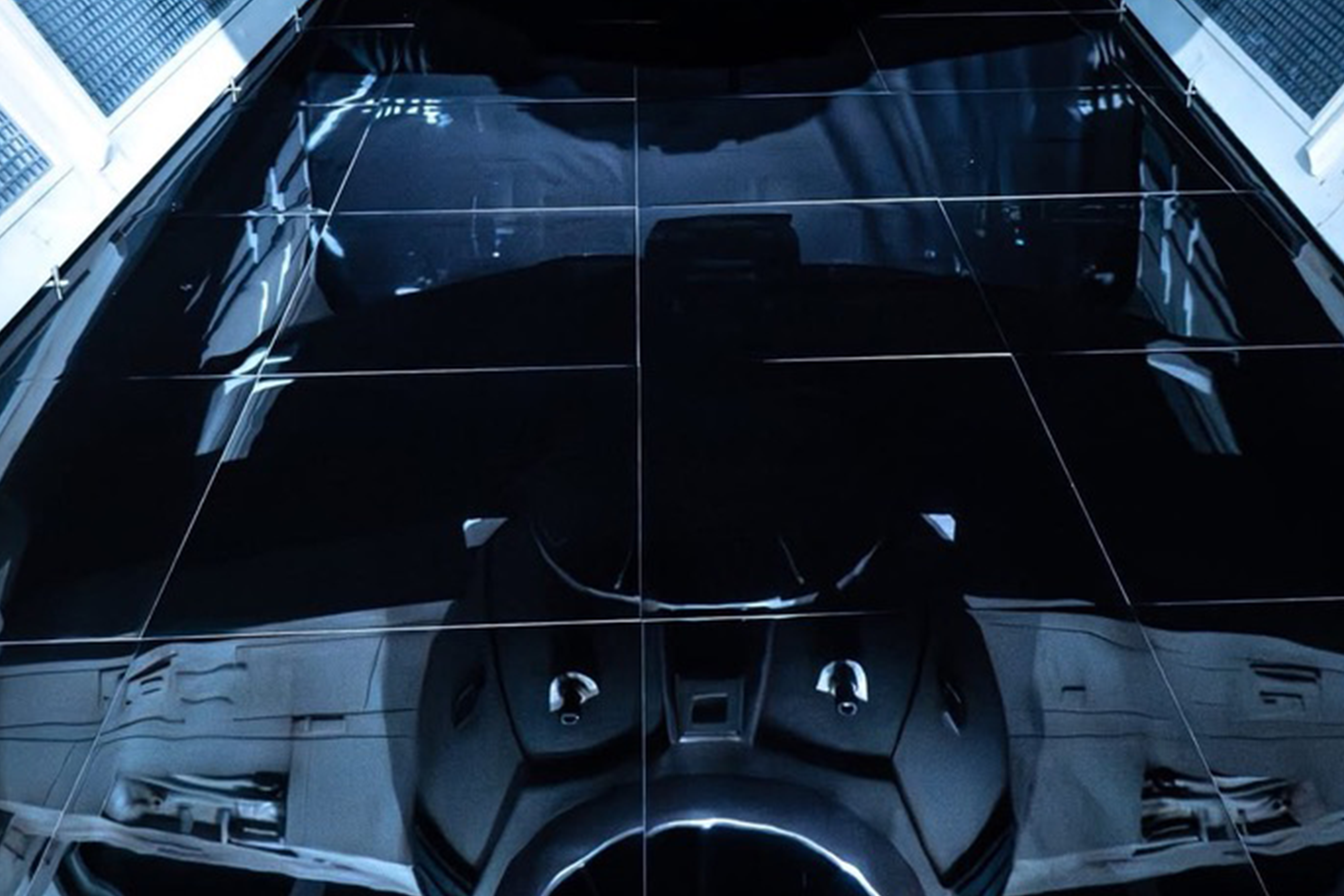 625 square feet of hand cut and installed high gloss “Imperial Tile” for the one and only dark reflection effect of the Empire.